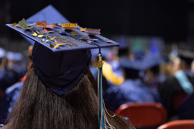Graduate tips their grad cap at commencement ceremony