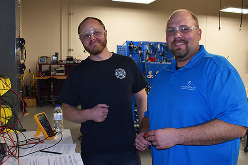 Students pose in the electro-mechanical tech lab