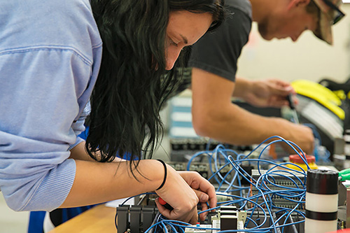 students work on electrical panels