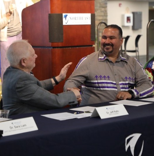 Oneida Nation Chairman Tehassi Hill, pictured shaking hands with NWTC President Emeritus Jeff Rafn