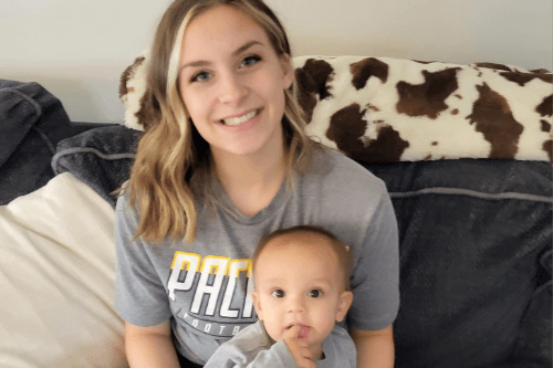 Emily, a soon-to-be practical nursing graduate, sits with one of her children.