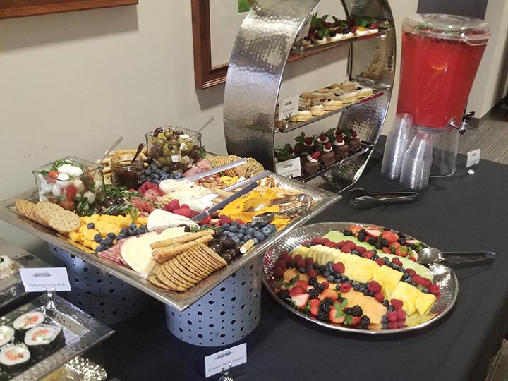 Spread of sushi, snacks and desserts on a table