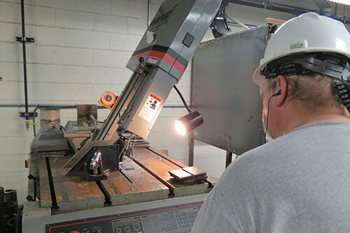 A worker uses a saw