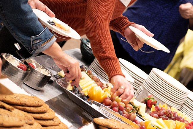 People take food from a buffet