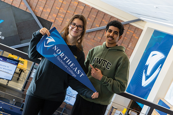 Two students hold NWTC swag in the Engineering Atrium