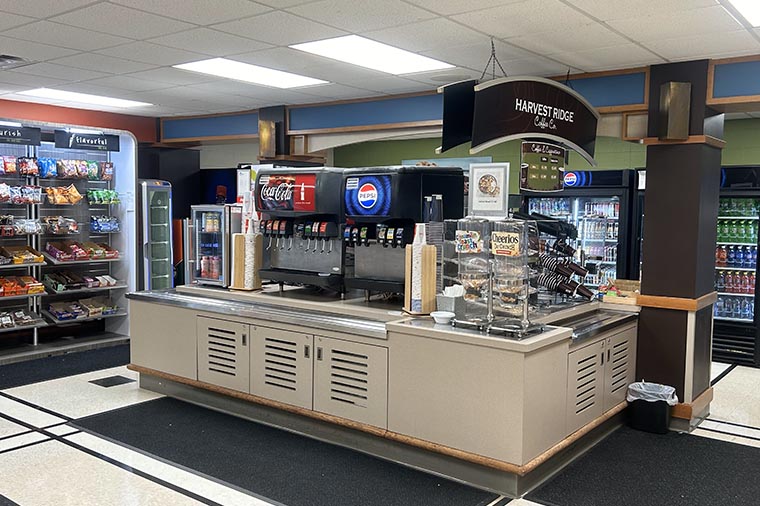 Cafeteria with racks of chips, snacks and drinks