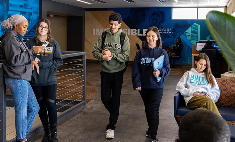 NWTC students walk down the hallway while talking